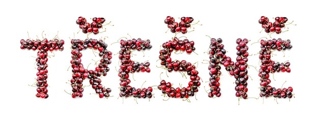 Sweet cherry - a sweet inscription from the berries of ripe cherries in Czech: tresne. Isolate on a white background, ready-made inscription for design and layout. Great gift and tasty treat