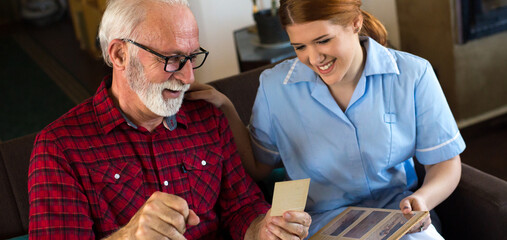 Senior man with nurse at home getting home care