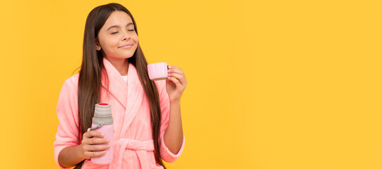 dreamy teen girl in home terry bathrobe with thermos bottle, thirsty. Horizontal poster of isolated child face, banner header, copy space. - obrazy, fototapety, plakaty