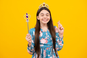 Portrait of girl princess in tiara holding magic wand. Teenager queen with golden crown.