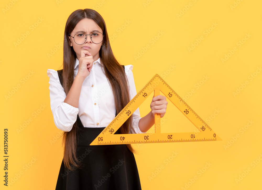 Poster thinking teen girl in uniform and glasses hold mathematics triangle for measuring, measurement.