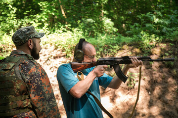 A Ukrainian civilian man is training to shoot