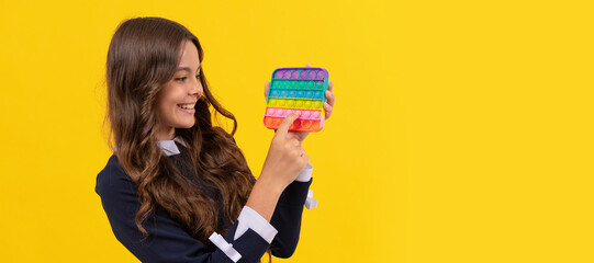 happy child playing with pop it silicone sensory fidget game, popit. Horizontal poster of isolated child face, banner header, copy space.