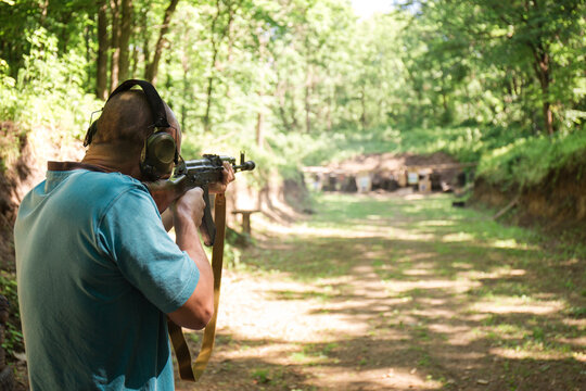 A Ukrainian man is training to shoot an Akm