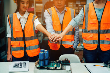 Closeup of team engineer and staff workers join hands together on construction site, success collaboration concept