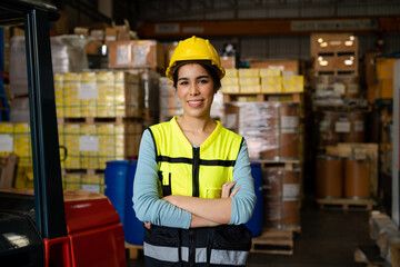 Portrait of female supervisor standing in warehouse with his arm crossed looking at camera.