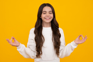 Teenager child in white shirt hold hands in yoga om aum gesture relax meditate try calm, isolated on yellow background.