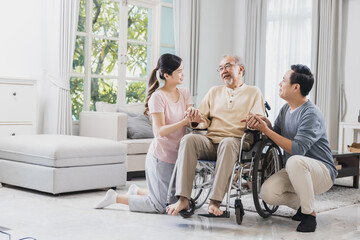 Happy family of senior with beautiful daughter and her husband, take care old man sitting on...