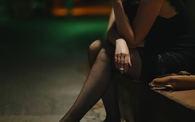 Female prostitute with cigarette on the street. - obrazy, fototapety, plakaty