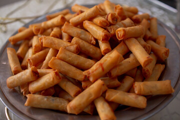 A plate full of deep fried spring roll or popiah, ready to be eaten