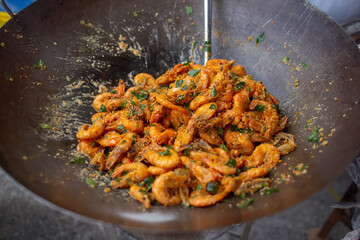 Prawns being deep fried inside a wok at Penang Malaysia.