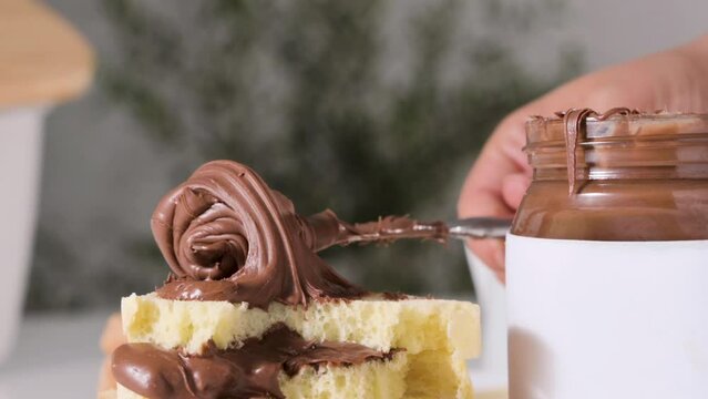 chocolate paste. Nut-chocolate paste for breakfast and favorite children's food. Closeup texture of pasta and gooey chocolate mixture. High quality 4k footage. Ideal for advertising and social posts