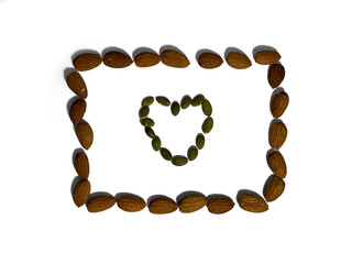 The frame for the photo is made of almonds. The frame made of almonds has a heart made of pumpkin...