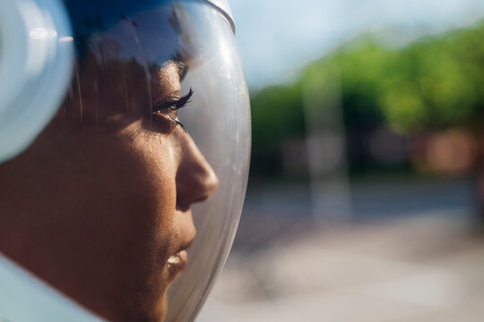 Businesswoman wearing astronaut helmet