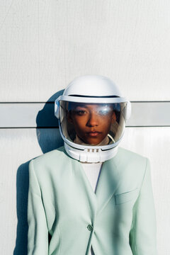 Serious businesswoman wearing astronaut helmet