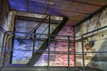 Industrial metal staircase in the old factory. Illuminated