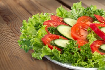 Fresh spring vegetable salad with tomatoes and peppers in the bowl.