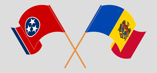 Crossed and waving flags of The State of Tennessee and Moldova