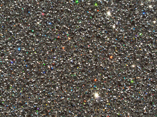 Luxurious Festive sparkling abstract background.  A festive holiday card. Macro sparkling silver black abstract background