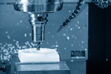The  CNC milling machine cutting the nylon 6 material part with flat end mill tool.