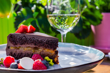 Piece of cake with strawberries, raspberries, blueberries, meringues