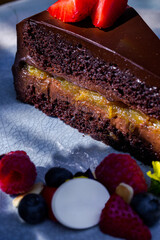 Piece of cake with strawberries, raspberries, blueberries, meringues