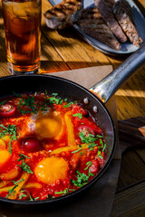 Fried eggs with peppers, parsley, tomatoes and ketchup