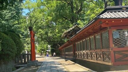 The stone path with beautiful Japanese architectural corridor wall, “Nezu” shrine in downtown Tokyo, year 2022 June 28th