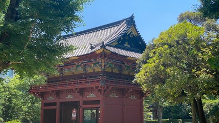 Colorful “Romon” two story high tower gate of “Nezu” shrine, beautiful summer sunlight and the historic zen scenery, year 2022 June 28th