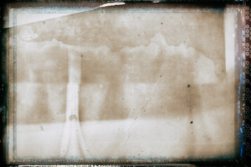 Vintage photo with film grain and frame wit wet plate technique – chapped concrete wall for artistic backgrounds