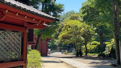 The stone path with beautiful Japanese architectural corridor wall, “Nezu” shrine in downtown Tokyo, year 2022 June 28th