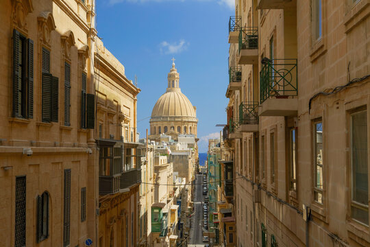 The Basilica of Our Lady of Mount Carmel (Bazilika Santwarju tal-Madonna tal-Karmnu) cupola, beyond Maltese houses, Valletta, Malta