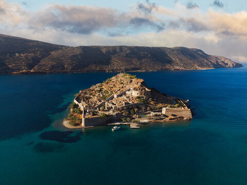 Aerial drone view of Spinalonga, deserted leper colony with fortifications, currently a tourist attraction, Crete, Greek Islands, Greece