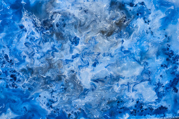 Blue ink abstract background, winter paint pattern under water, acrylic pigment stains, splashes and streaks