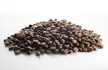 Roasted coffee beans isolated close up on white background, clipping path
