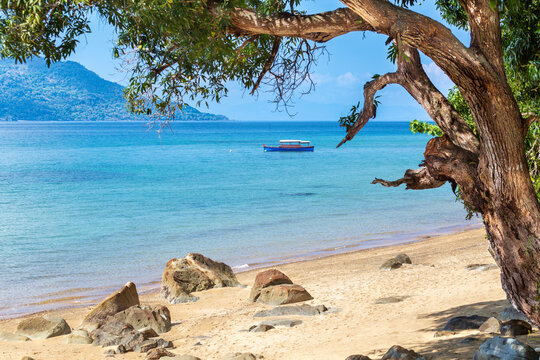 Boat anchored off the beach at Nosy Komba island, North West Madagascar, Indian Ocean