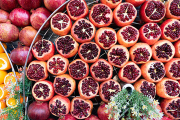 Rows of ripe pomegranates cut on one side