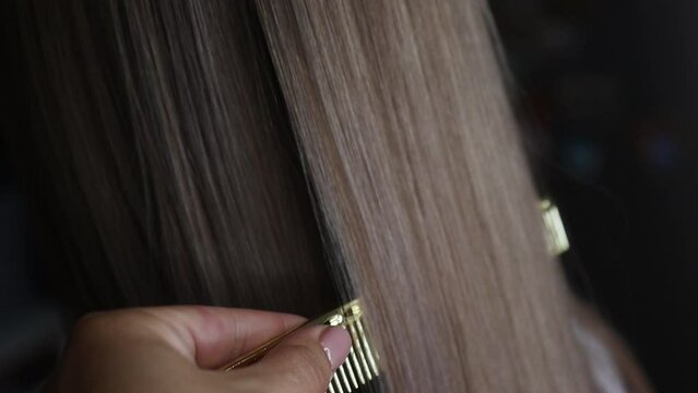 girl straightens her hair with keratin
