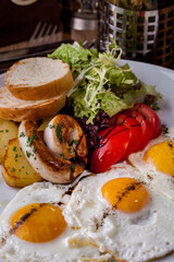 Fried eggs from three eggs with grilled sausage