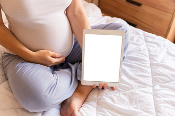 Pregnancy mockup display. Pregnant woman holding smart tablet. Mobile pregnancy online maternity application mock up. Concept maternity, pregnancy, childbirth.