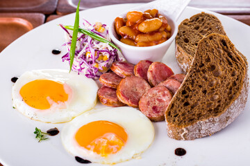 Fried eggs from two eggs and grilled sausages