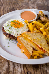Fried eggs with cutlet and sandwiches