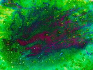 Horizontal image showing a colorful texture made of acrylic and watercolor paint with glitter with a vibrant and sparkly effect