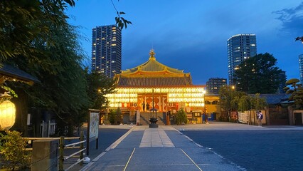 The path to the beautiful Japanese temple at night with Japanese paper lanterns lit in gold, the...