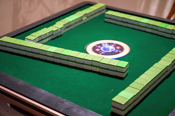 A close-up of an automated mahjong table