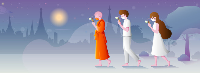 Buddhists walking with lighted candles in hand around a temple to pay respect and belief to religion