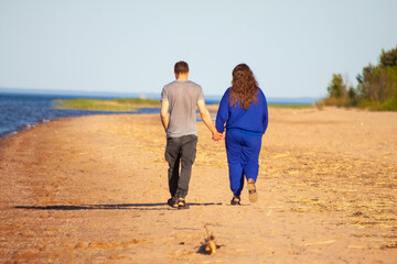 Couple in love walking on the beach in summer