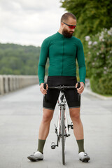 Fototapeta premium A cyclist in motion. Bike ride along the embankment along the river.