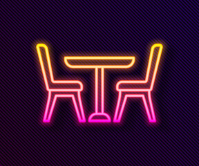 Glowing neon line Wooden table with chair icon isolated on black background. Vector