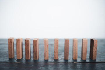 Wooden blocks and domino effect risk management concept business success, problem solving, strategy...